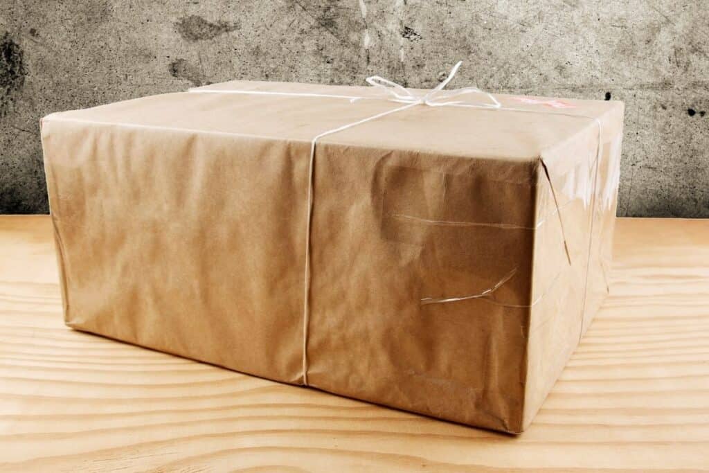 brown paper wrapped package sitting on table