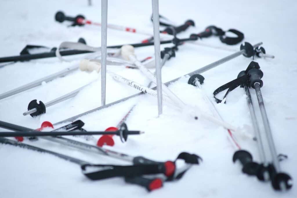 collection of ski poles laying on ground