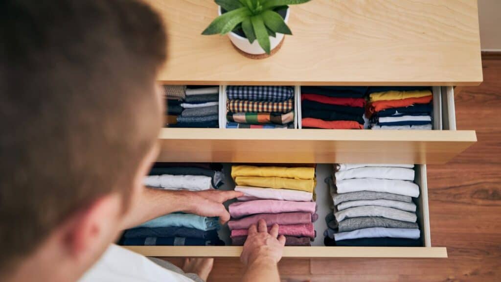 man considering what clothes to put on